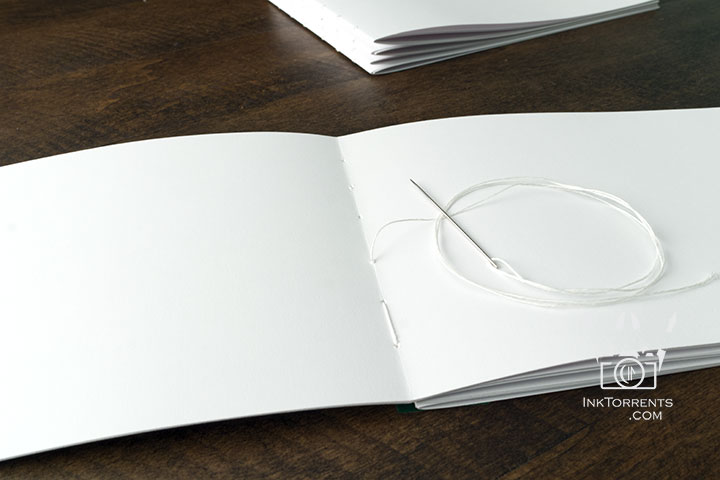 Hand-stitching a book signature during the bookbinding process — InkTorrents Graphics