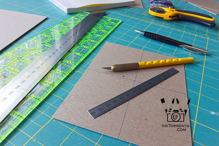 Rulers and trimmer used to cut the cover inset for a handmade notebook — InkTorrents Graphics