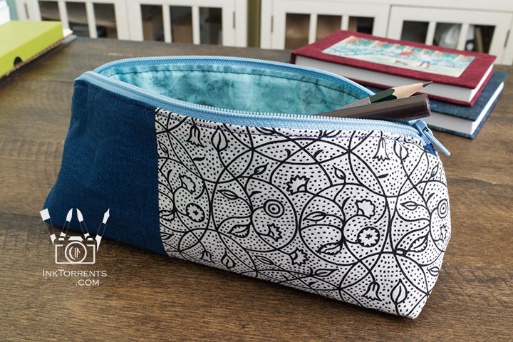 Handmade triangular zippered pencil case in printed cotton and faux leather, self-drafted pattern, by InkTorrents Graphics