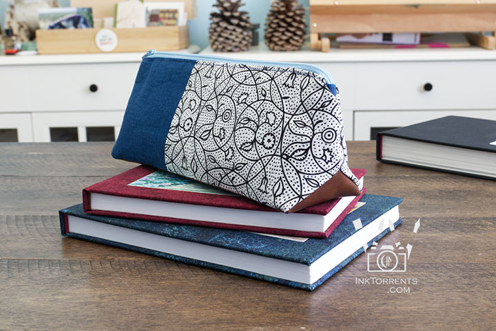 Handmade triangular zippered pencil case in printed cotton and faux leather, self-drafted pattern by InkTorrents Graphics